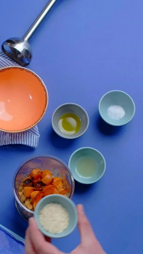 Vertical flat lay video: chef adds ingredients of the humus with nutt and carrot Stock Footage 179008695