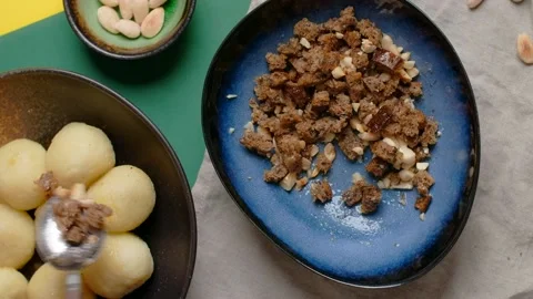 Vertical flat lay video: chef sprinkles bread crumbs on potato dumplings Stock Footage 183527802