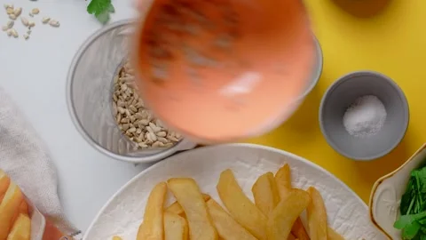 Vertical flat lay video: chef adds parsley and sunflower seeds to the blender Video stock 184449676