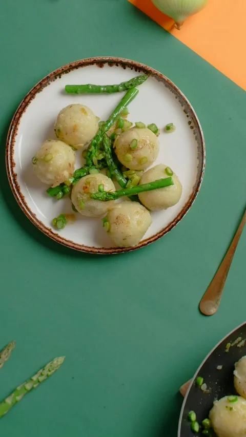 Vertical flat lay video: the cook puts plate of cooked potato dumplings with Stock Footage 179924461