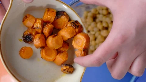 Vertical flat lay video: cooking humus, chef adds fried carrot to the nutt in Stock Footage 180578034