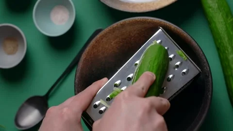 Vertical flat lay video recipes: chef grates cucumber on the grater Stock Footage 180946423