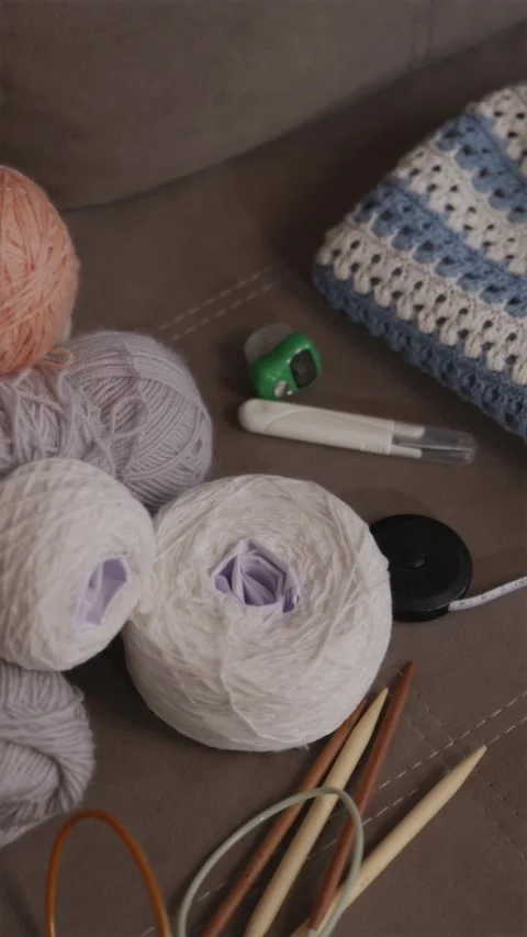 Vertical flatlay of knitting essentials and handmade summer top Stock Footage 337451996