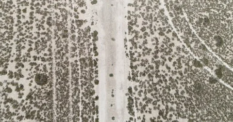 Vertical flight with drone ascending from desert to dry lagoon Stock Footage 210430252