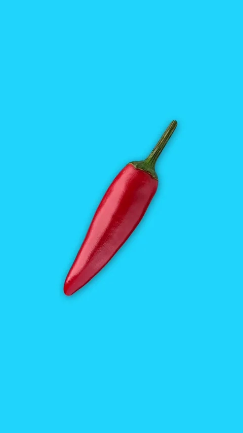 Vertical Flying Chili Pepper Breaking with Spices – Blue Chromakey Background Stock Footage 310737702