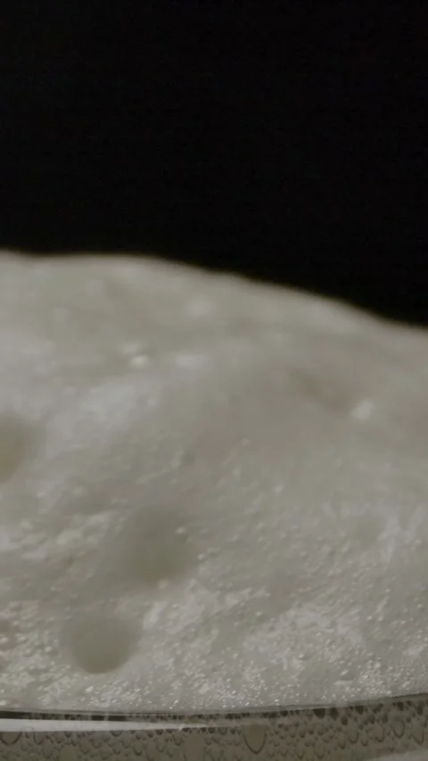 Vertical of Foam bubbling on top of beer mug. Stock Footage 276918352