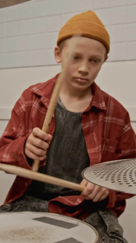 Vertical of Focused Boy Practicing Drums and Playing Snare Drum in Studio Stock Footage 339190024