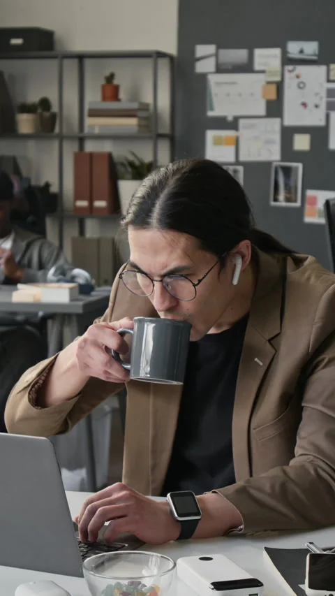 Vertical of Focused Male Programmer with Glasses Working on Laptop in Office Stock-Footage 336708925