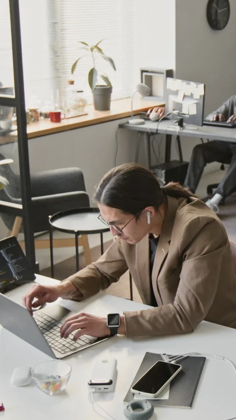 Vertical of Focused Man Software Developer Coding on Laptop in Office Stock Footage 337470663