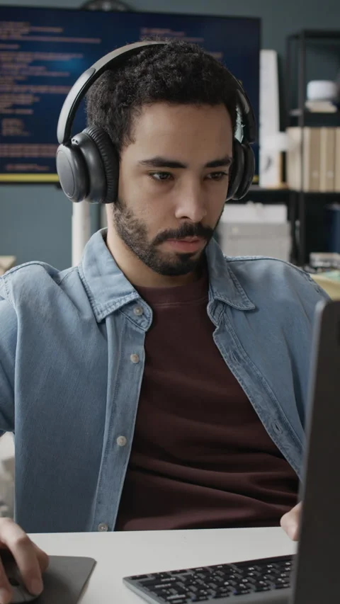 Vertical of Focused Middle Eastern Employee Coding on Laptop in Office Stock Footage 337484193