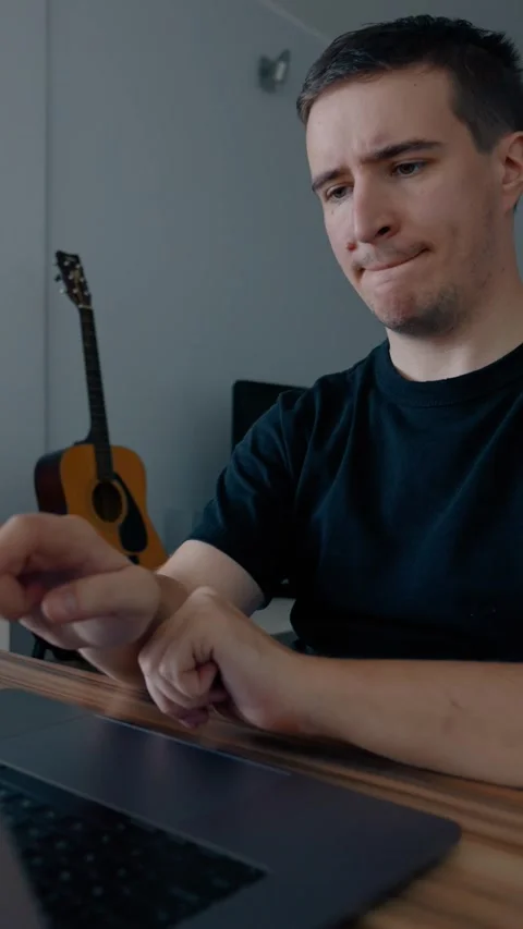 Vertical of Focused programmer develops new game on laptop at home Stock Footage 274153676