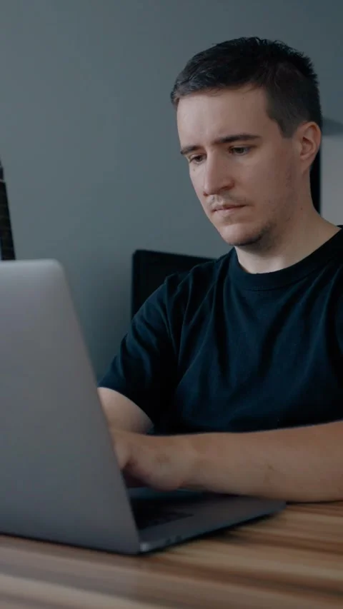 Vertical of Focused programmer develops new website on laptop at home Stock Footage 274154633