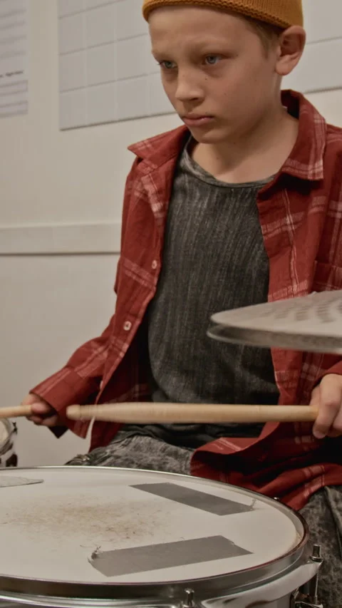Vertical of Focused Teenage Boy Practicing Snare Drum in Music Class Stock Footage 339187109