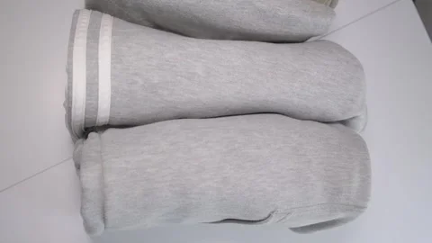Vertical folding of clothes on a shelf in a closet. Order with clothes Stock Footage 241024328