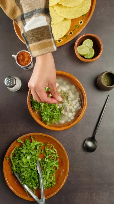 Vertical food video adding chili powder to pozole, September holidays Stock Footage 280360915