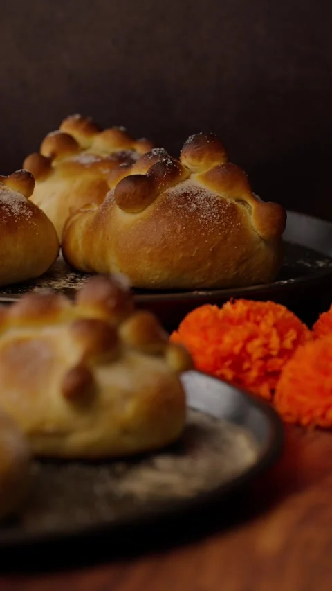 Vertical food video, bread of the dead next to some cempasuchil flowers Stock Footage 282499418