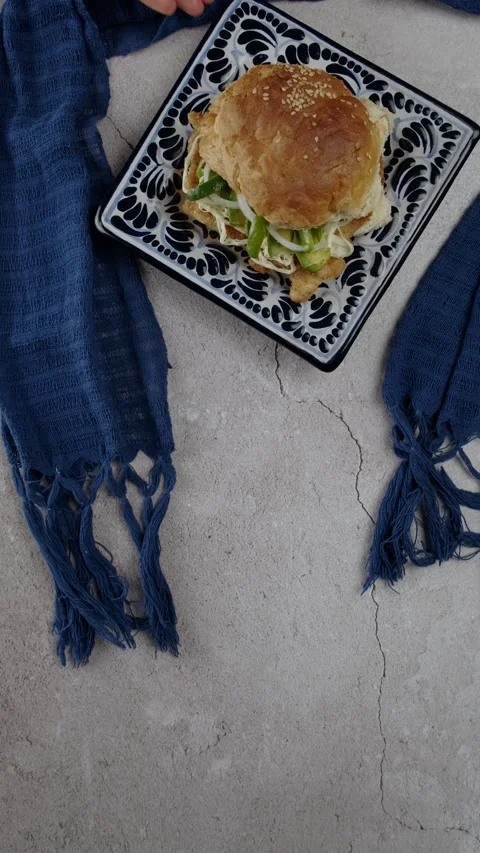 Vertical food video Cemita poblana on a talavera plate and a blue rebozo Stock Footage 280326326