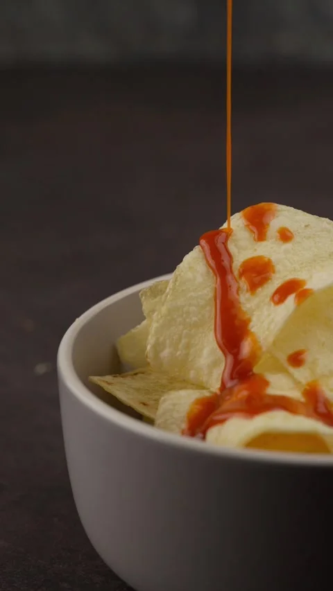 Vertical food video serving spicy red sauce over french fries Stock Footage 280327012