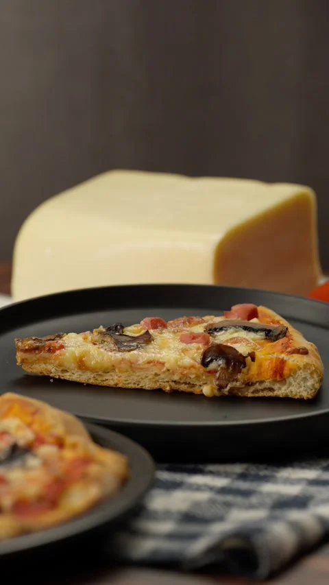 Vertical food video, a slice of pizza on a dark plate Stock Footage 282564630