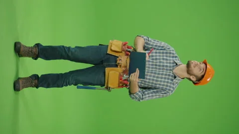 Vertical Footage. Bearded ,Looking Around and Correcting the Blueprints Video stock 224784808