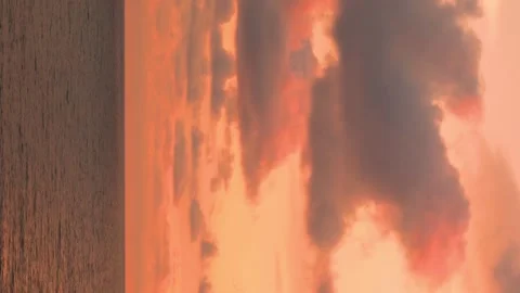 Vertical footage, beautiful view of the ocean beach and sunset yellow red sky cl Stock Footage 334942117