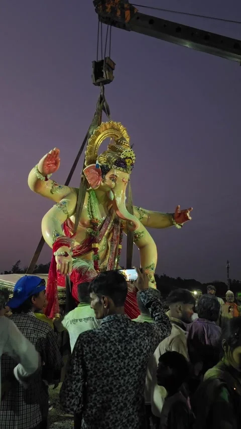 Vertical footage of Big statue of Lord Ganesha Visarjan with Heavy-duty cranes. Stock Footage 346395995