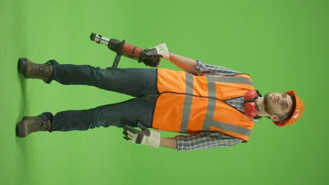 Vertical Footage. Civil Engineer Lifting the Perforator Up and Looking Straight Stock Footage 224788670