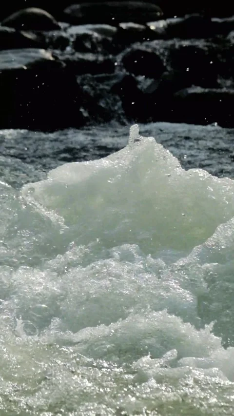 Vertical footage of a clear mountain river flowing rapidly through river rocks Stock-Footage 320922379