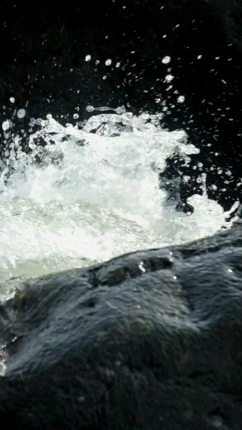 Vertical footage of a clear mountain river flowing rapidly through river rocks Stock-Footage 320922588