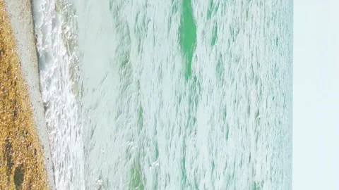 Vertical footage, close-up, waves wash over the sandy beach by the sea, s 스톡 동영상 334928744