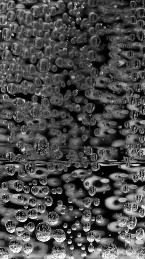 Vertical footage of clusters of dense bubbles rising up gradually in liquid. 스톡 동영상 337451039
