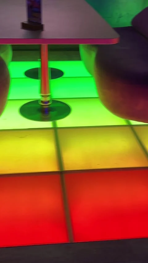 Vertical footage of glowing multicolored LED dance floor inside a modern Stock Footage 346688905