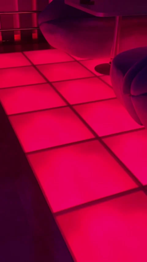 Vertical footage of glowing multicolored LED dance floor inside a modern Stock Footage 346689182