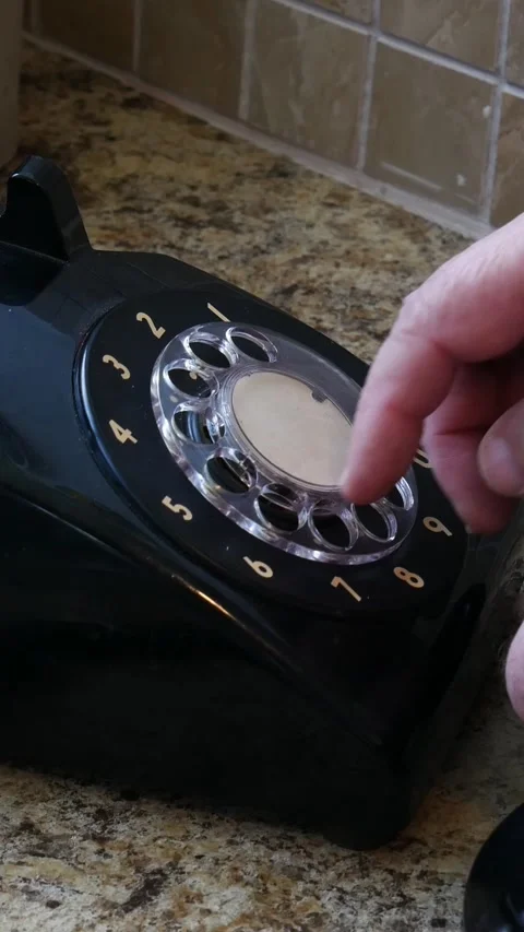 Vertical Footage of Hand makes call on rotary dial phone Stock Footage 235870738