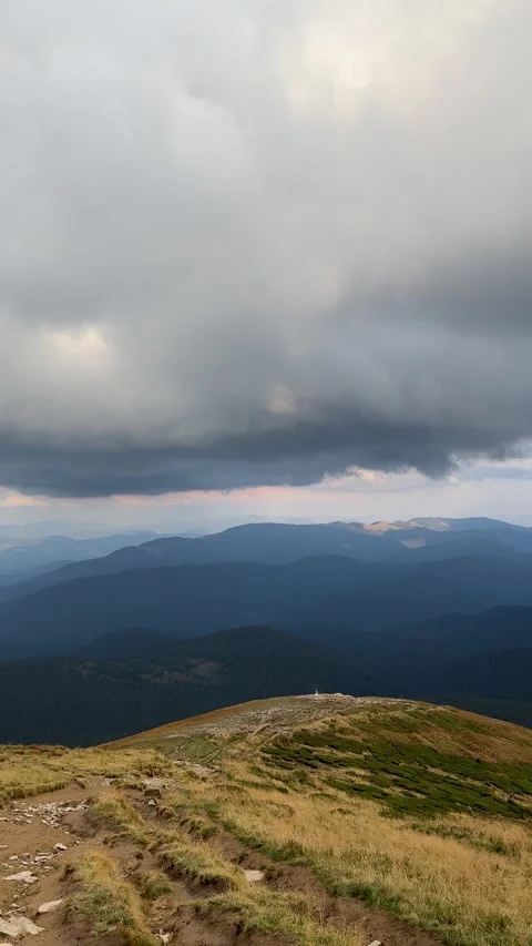 Vertical footage of hiking path with storm clouds over mountain range Stock Footage 293142190