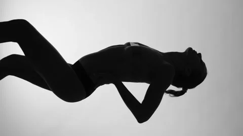 Vertical footage of a silhouette in contrast, a study of light and form Stock Footage 263148008