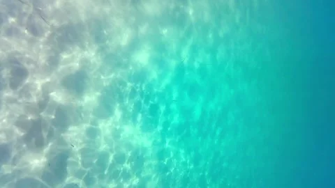 Vertical footage of sunrays reflected at the sand of the sea bottom Video stock 159022204