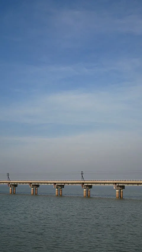 Vertical footage of train tracks bridge over the river in day time Video stock 236825275