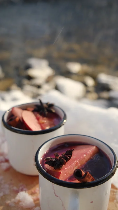 Vertical footage of two mugs with hot mulled wine or gluhwein with spices Stock Footage 300943202