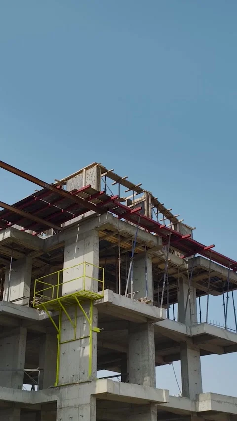 Vertical Footage Urban Construction Site with Workers Moving Materials Stock Footage 341731083
