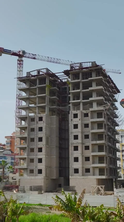 Vertical Footage Urban Development with Construction Equipment and Materials Stock Footage 341730363