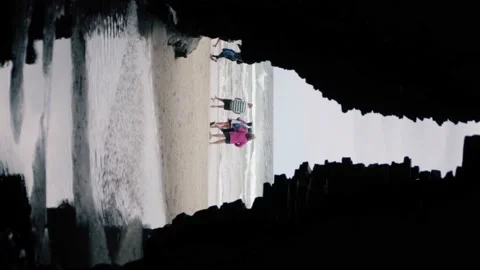 Vertical footage of the view from inside a cove of tourist in very popular beach Stock Footage 219306215