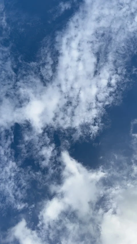Vertical footage of white clouds floating across the blue sky. Moving clouds Stock Footage 301455408