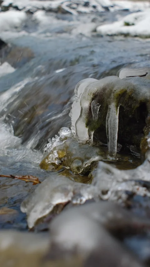 Vertical footage of winter waterfall river close up. Crystal water in mountains Stock Footage 297962055
