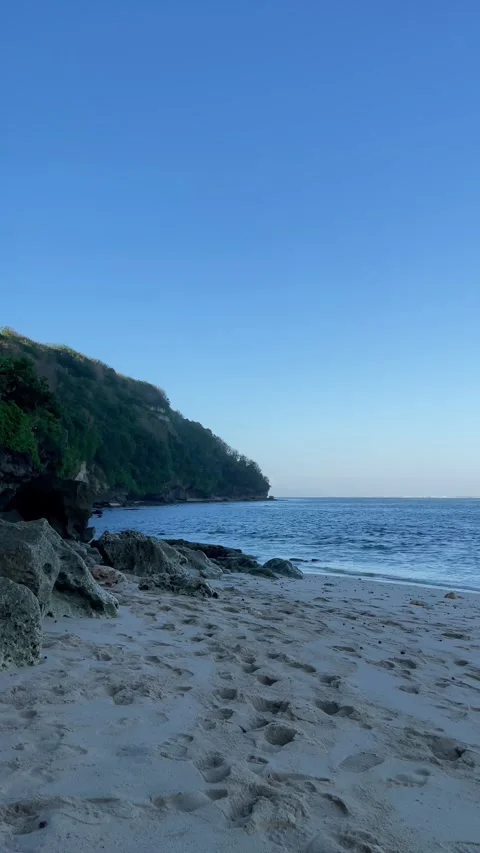 Vertical Footprints on White Sand Beach and Coastal Cliff in Bali Stock Footage 337336425