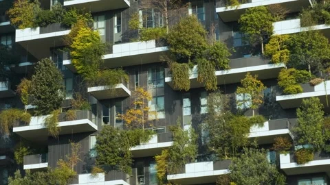 Vertical forest building with lush greenery and trees integrated into modern Stock Footage 293502357