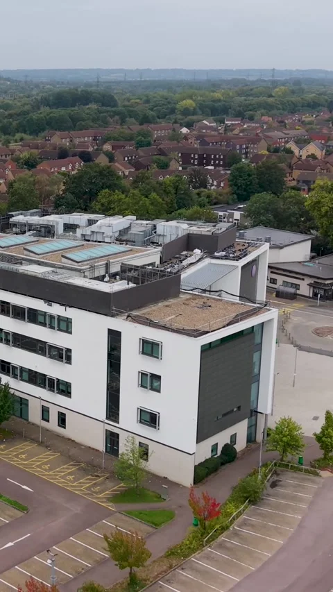 Vertical format aerial drone orbit Hertford Regional College Cheshunt UK, car Stock Footage 317611706