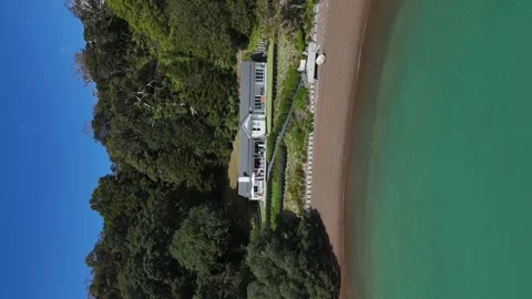Vertical format aerial view of Tahapuke Lodge in Russell New Zealand Stock Footage 333028905