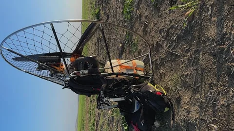 Vertical format: Camera pulls into Paramotor engine and steel frame Stock Footage 262306528