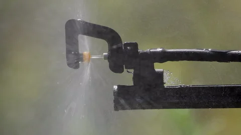 Vertical format close up of garden sprinkler spraying water and mist Stock Footage 320171477
